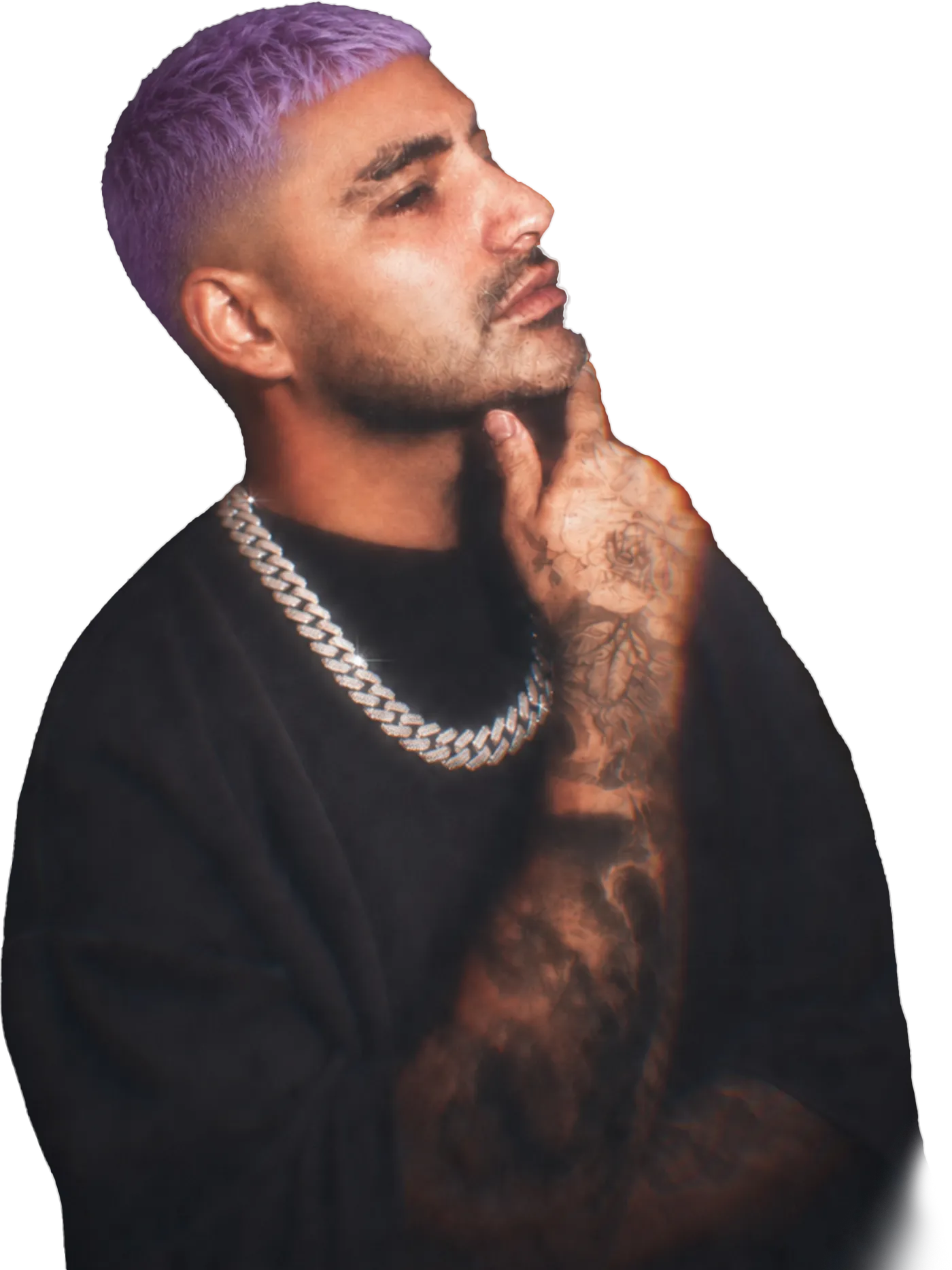 Gabe Amaya, with purple hair and a silver chain, resting his chin on his hand
